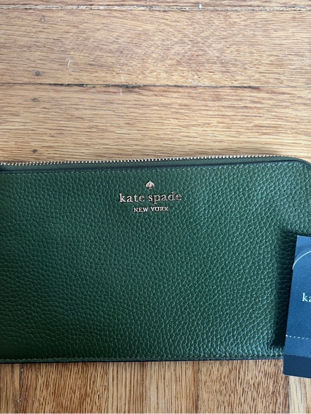 kate spade Lucy L Zip Wristlet in pebbled green leather.